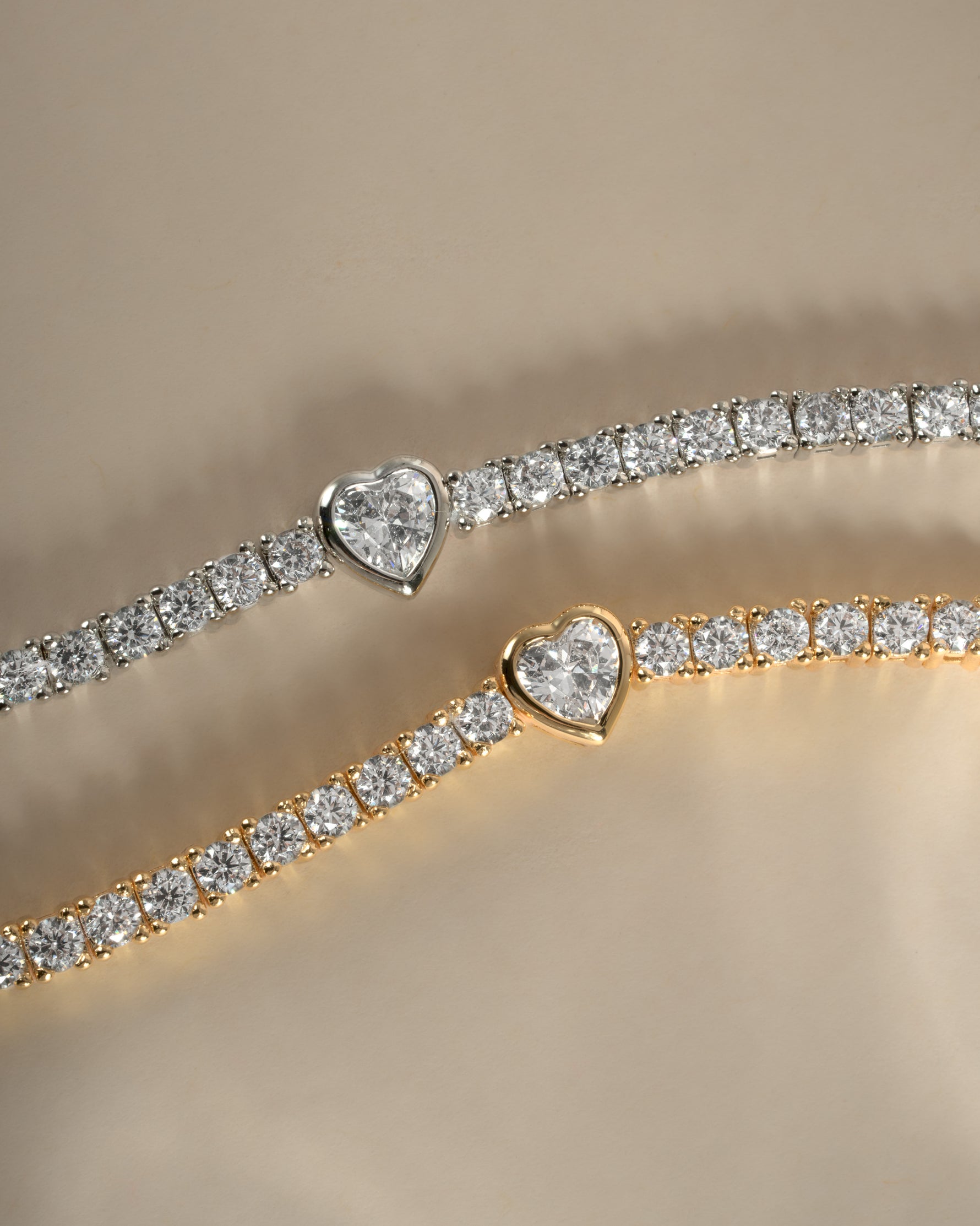Gold and silver heart charm tennis bracelet by Sami Jewels featuring delicate, sparkling links and a charming heart pendant.