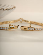 Gold Heart Charm Tennis Bracelet by Sami Jewels featuring a box clasp closure and delicate heart-shaped charms.