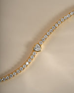 Close-up of Sami Jewels Heart Charm Tennis Bracelet in gold, showcasing the delicate heart-shaped charms on a sleek tennis bracelet.