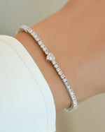 Silver Sami Jewels Heart Charm Tennis Bracelet featuring delicate heart-shaped charms on a sleek tennis bracelet design.