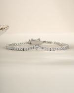 Silver heart charm tennis bracelet by Sami Jewels featuring a delicate chain and elegant heart-shaped charms.
