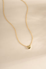 Gold heart necklace from Sami Jewels featuring a front view pendant design on a delicate chain.