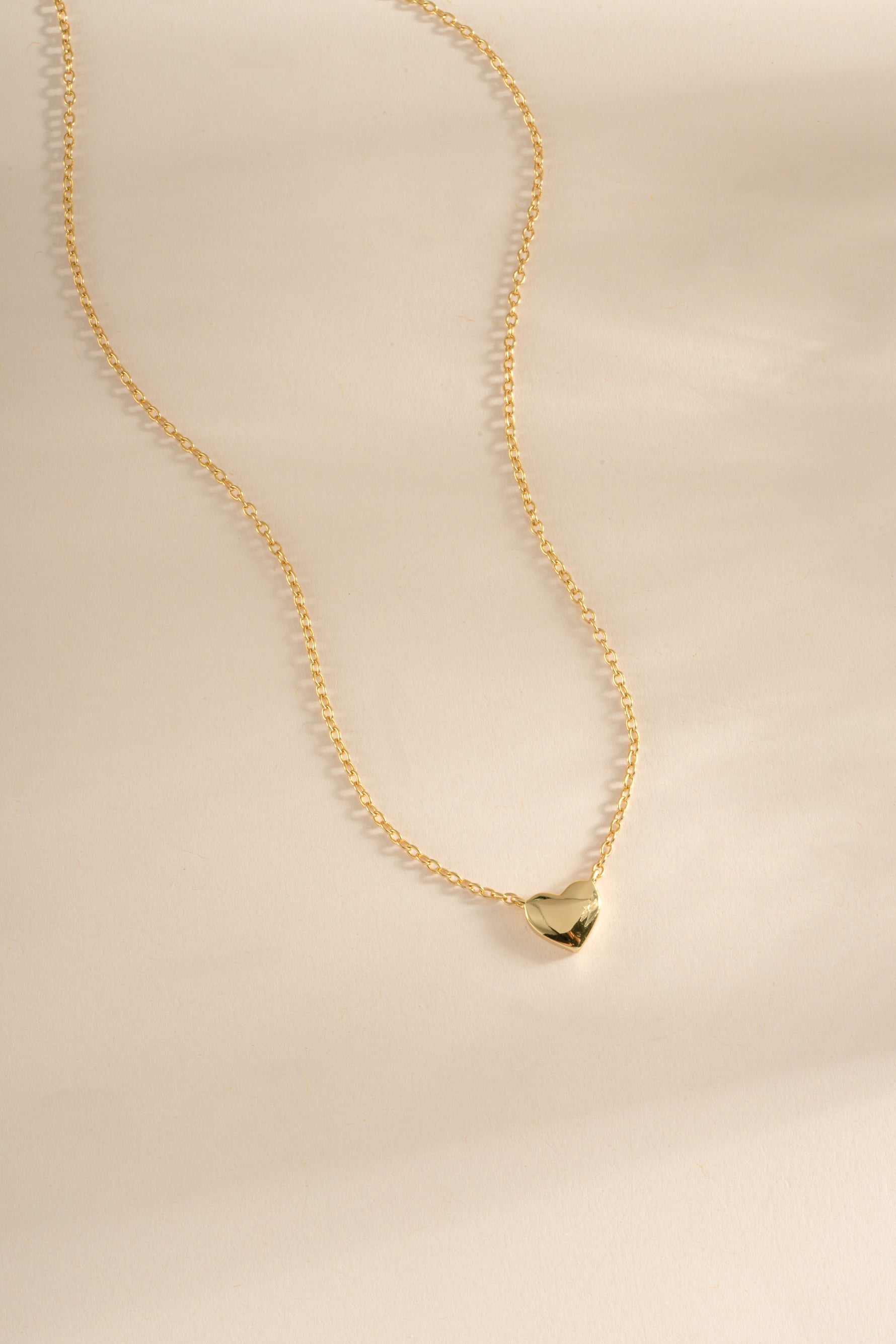 Gold heart necklace from Sami Jewels featuring a front view pendant design on a delicate chain.