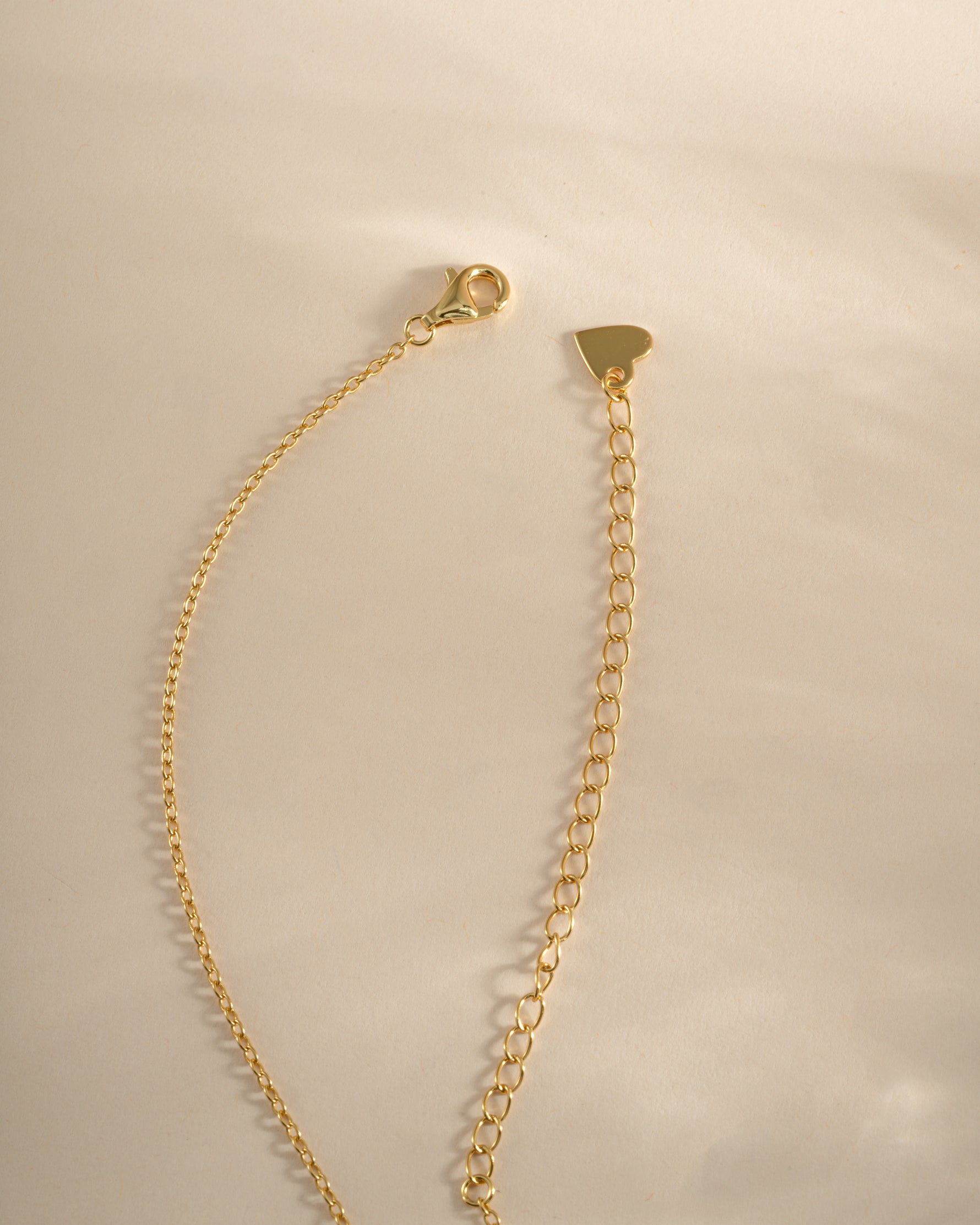 Gold heart necklace from Sami Jewels with lobster clasp closure, featuring a delicate and elegant design.