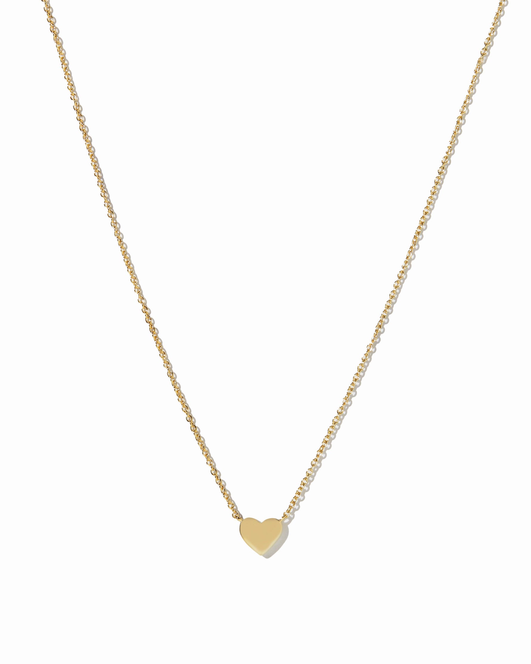 Gold heart necklace from Sami Jewels with a delicate chain, displayed against a white background.