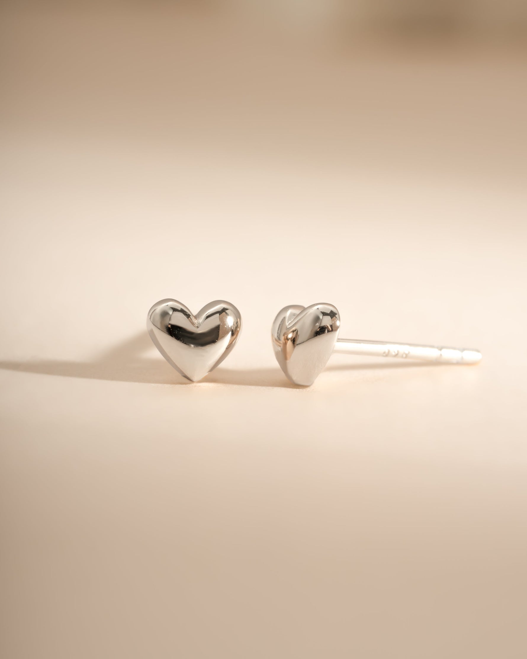 Sterling silver heart-shaped stud earrings by Sami Jewels, showcasing delicate and stylish jewelry design.