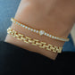 gold heart tennis bracelet paired with a gold link bracelet