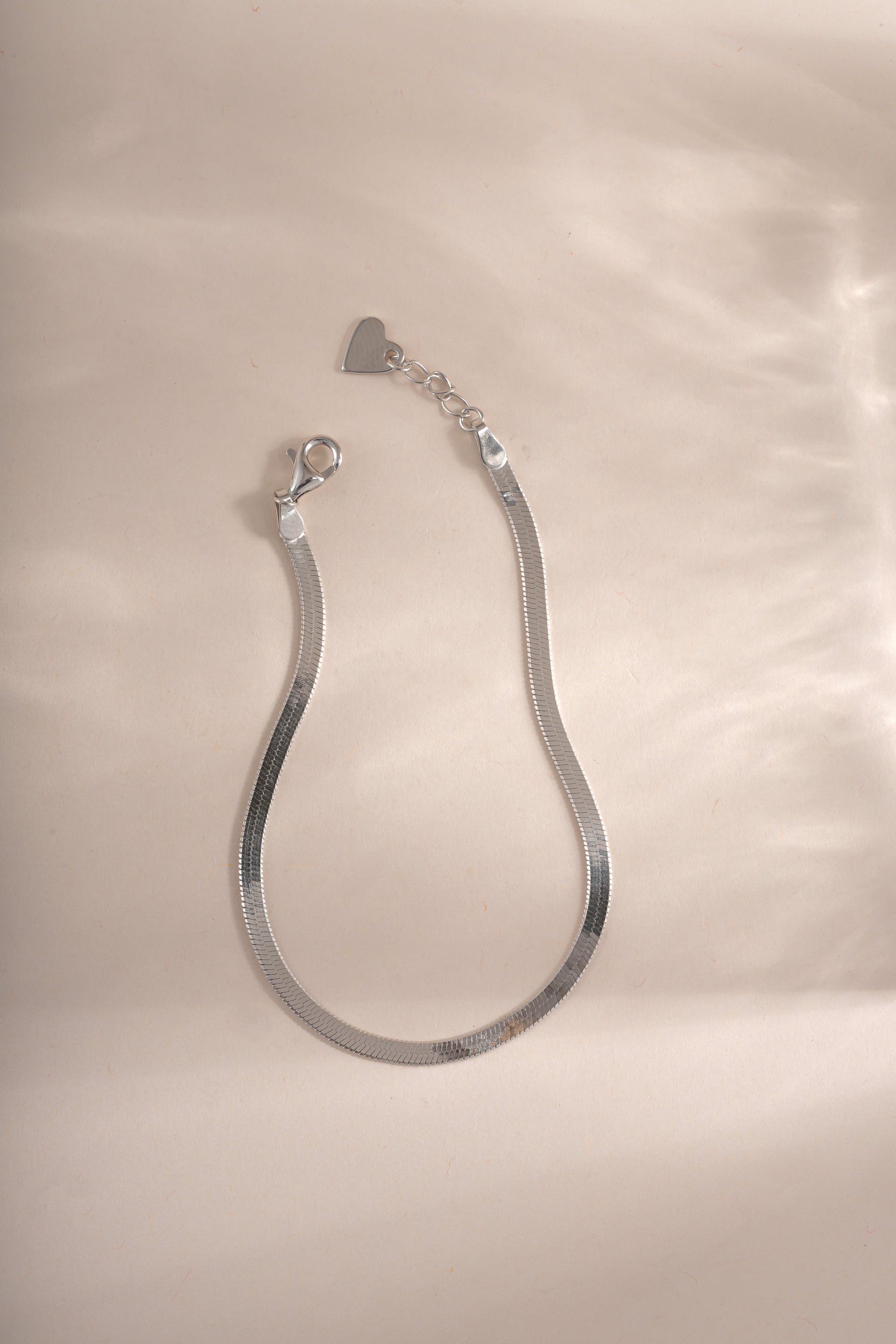 Sterling silver 2mm herringbone bracelet by Sami Jewels featuring a sleek, woven chain design.