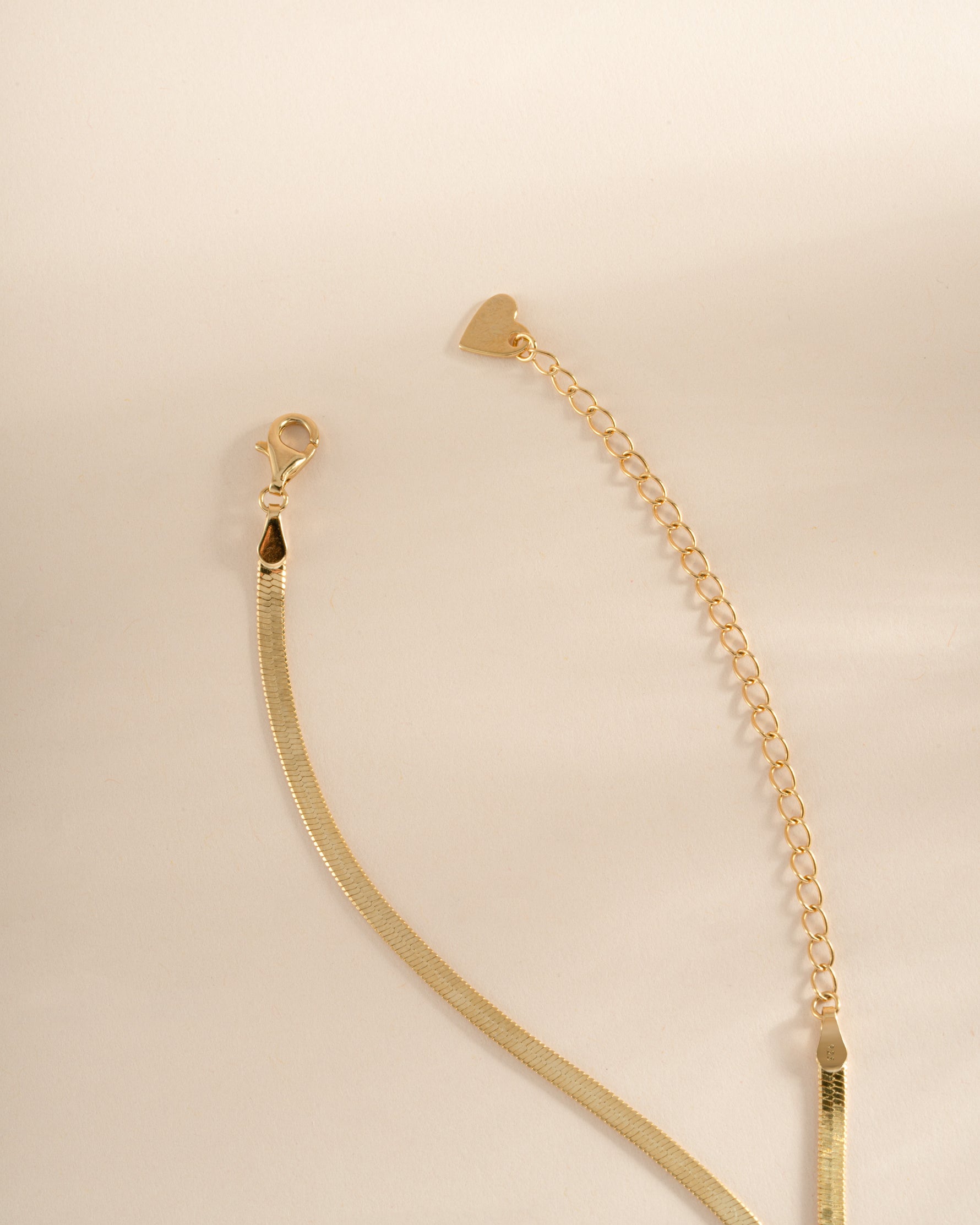Gold 2mm herringbone chain necklace from Sami Jewels, featuring a smooth, flat woven design for elegant everyday wear.
