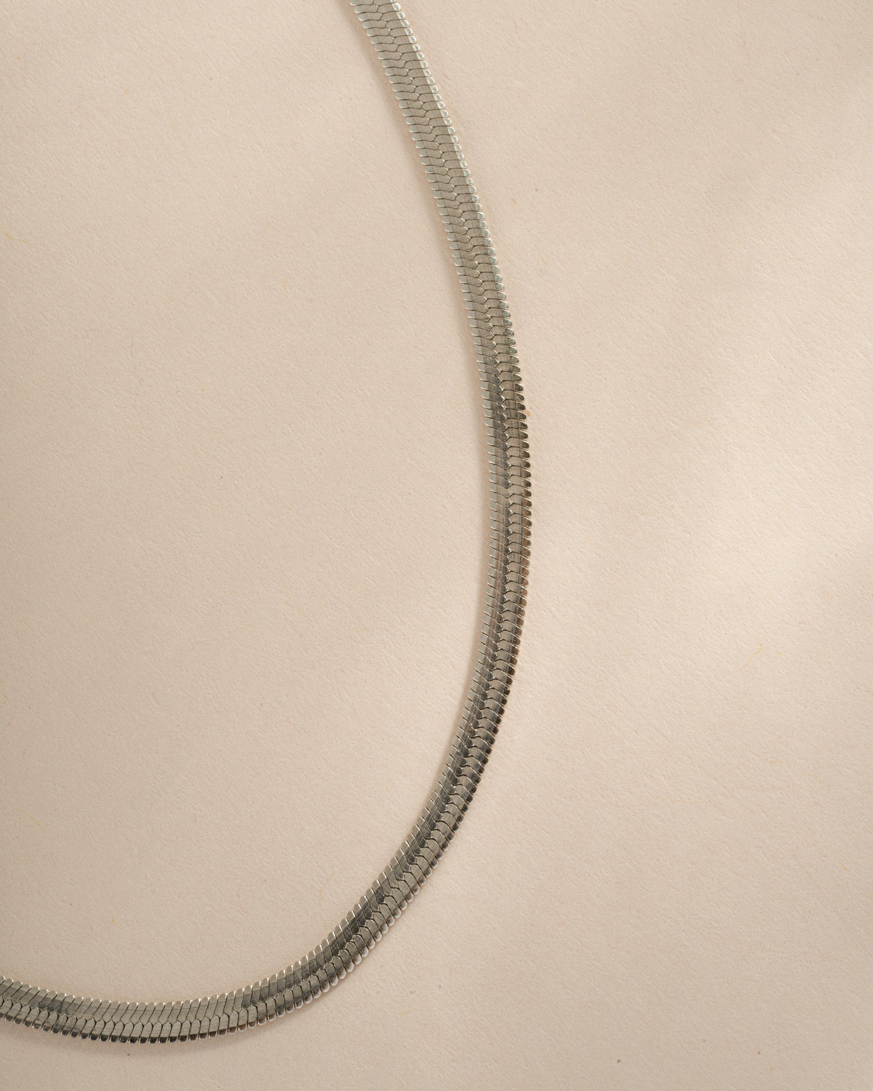 Silver 2mm herringbone chain necklace by Sami Jewels, showcasing a sleek, flat woven design with a polished finish.
