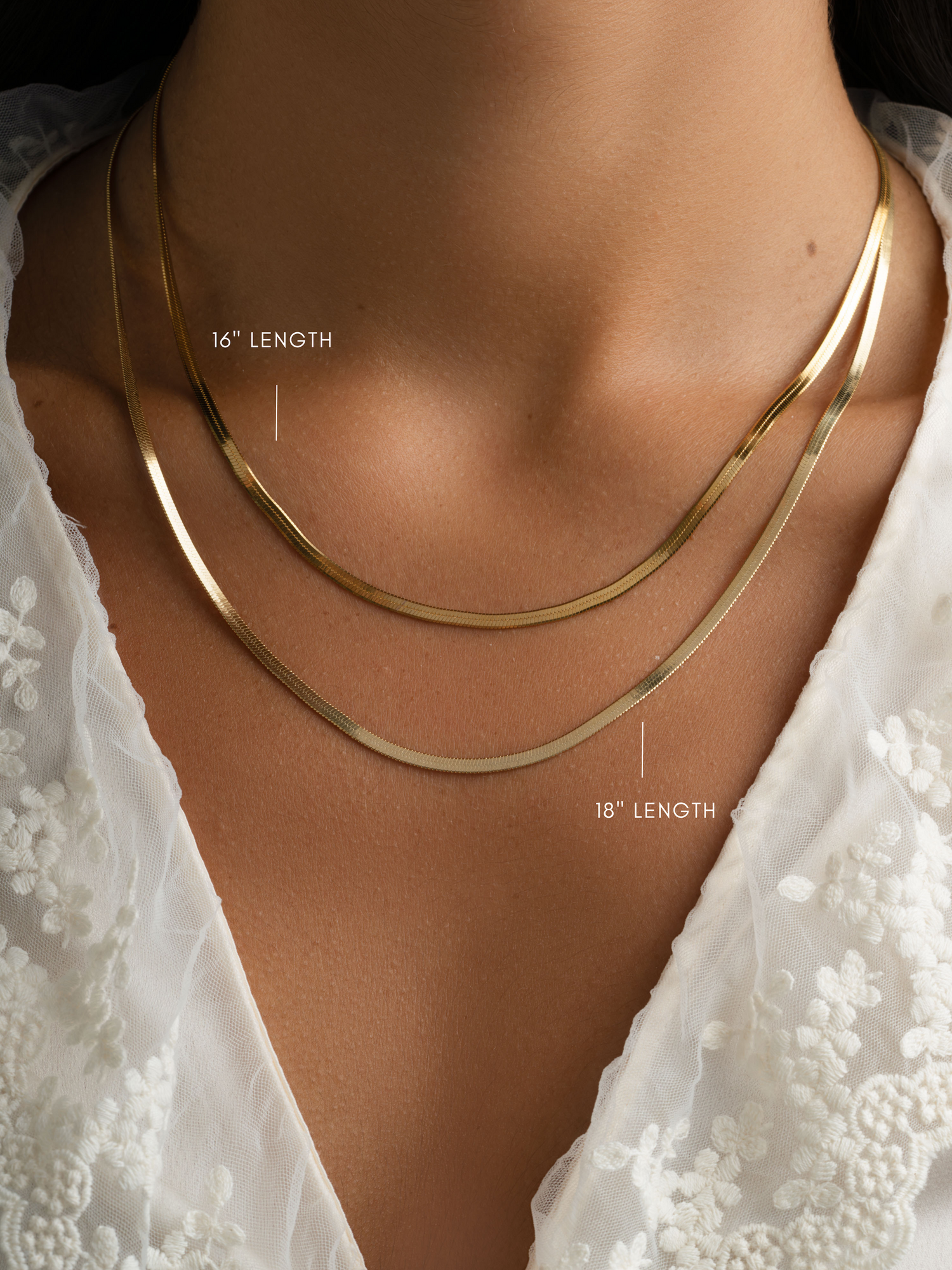 Gold 2mm herringbone chain necklace from Sami Jewels with a sleek, flat woven design on a white background.