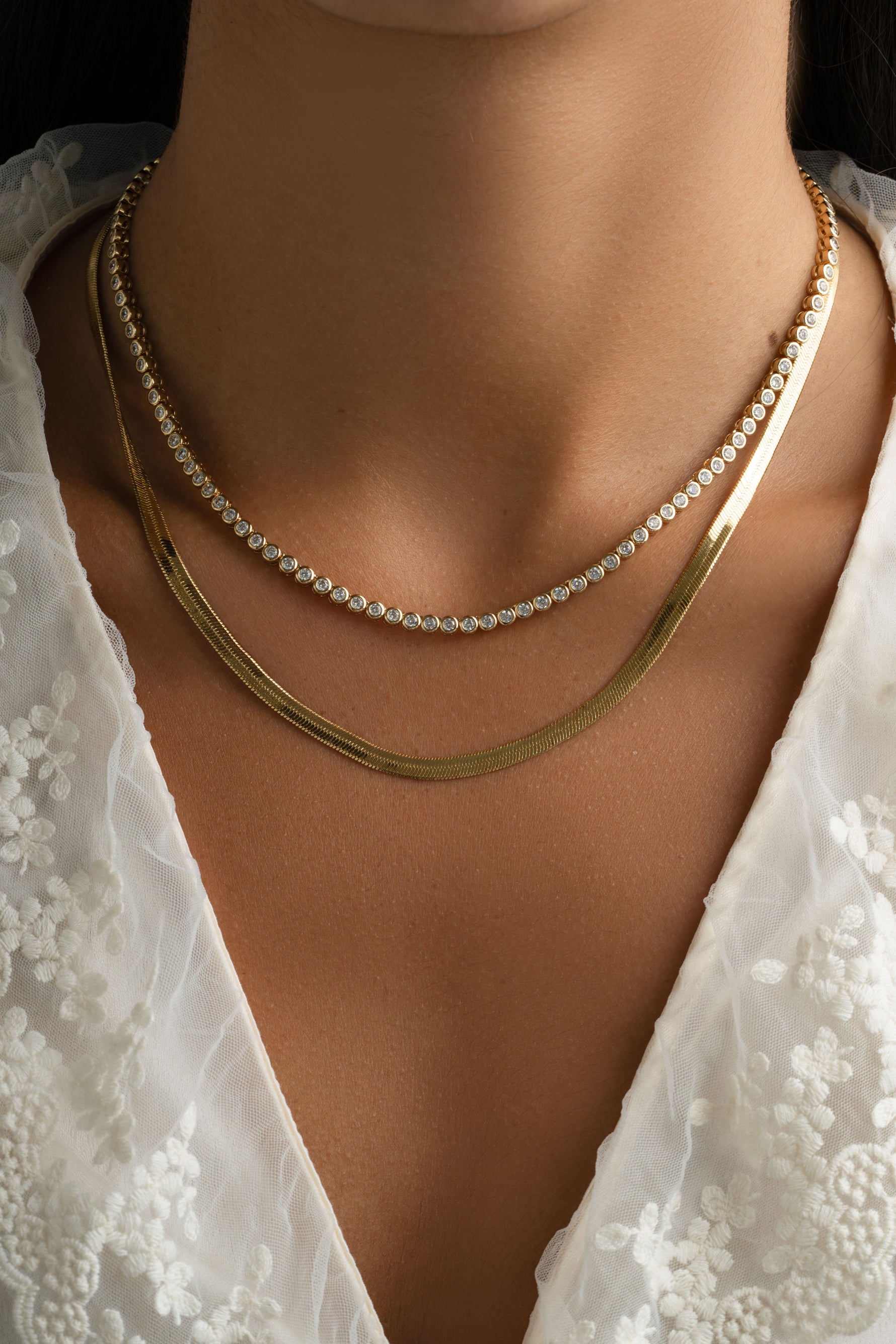 Gold 4mm herringbone necklace by Sami Jewels featuring a sleek, flat woven chain design on a neutral background.