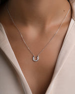Sterling silver horseshoe necklace with baguette accents from Sami Jewels, featuring a detailed jewelry design.