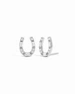 A pair of silver horseshoe-shaped stud earrings set with small baguette-cut clear stones, shown against a plain white background.