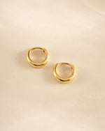 Gold minimalist huggie hoop earrings by Sami Jewels, side profile view showing sleek, simple design.