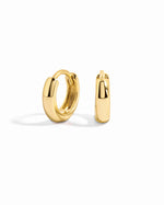 Gold minimalist huggie earrings by Sami Jewels displayed on a white background.