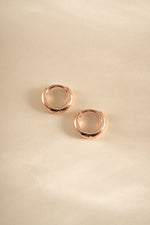 Rose gold Sami Jewels minimalist huggie hoop earrings with sleek, simple design perfect for everyday wear.