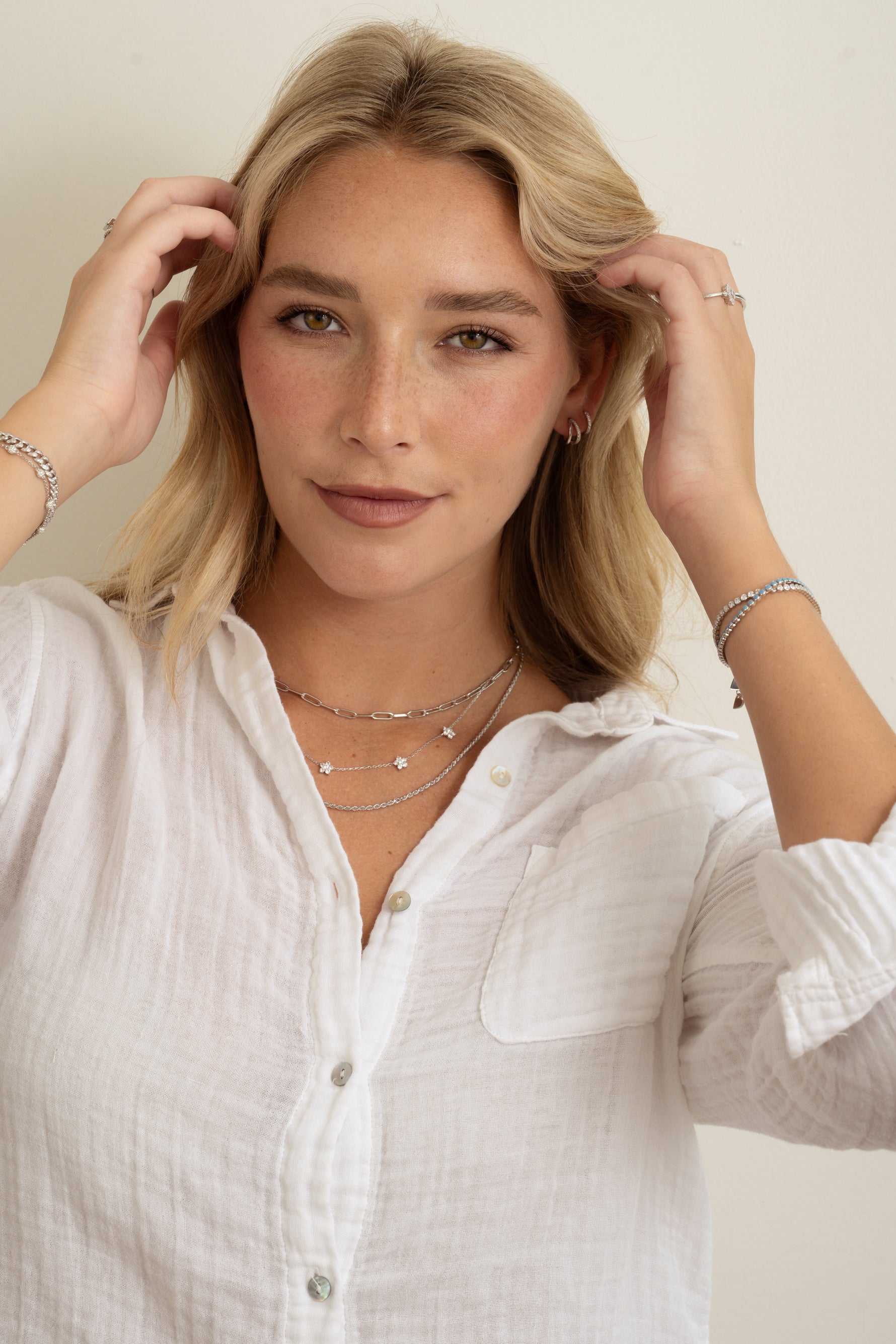 model wearing silver jewelry