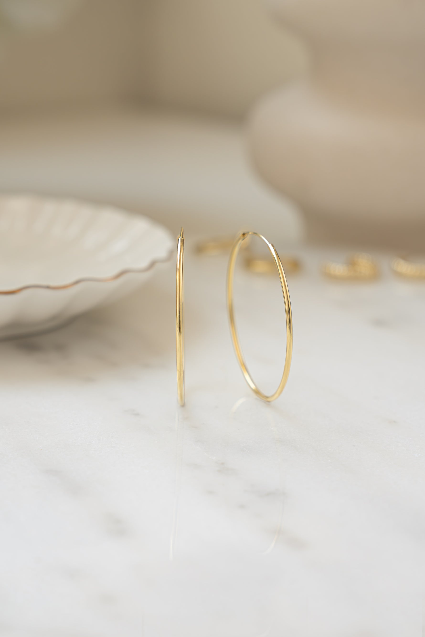 infinity hoop earrings in gold in 43mm 