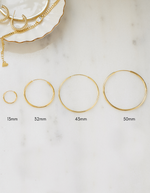 infinity hoop earrings in gold in different sizes ranging from 13mm-50mm