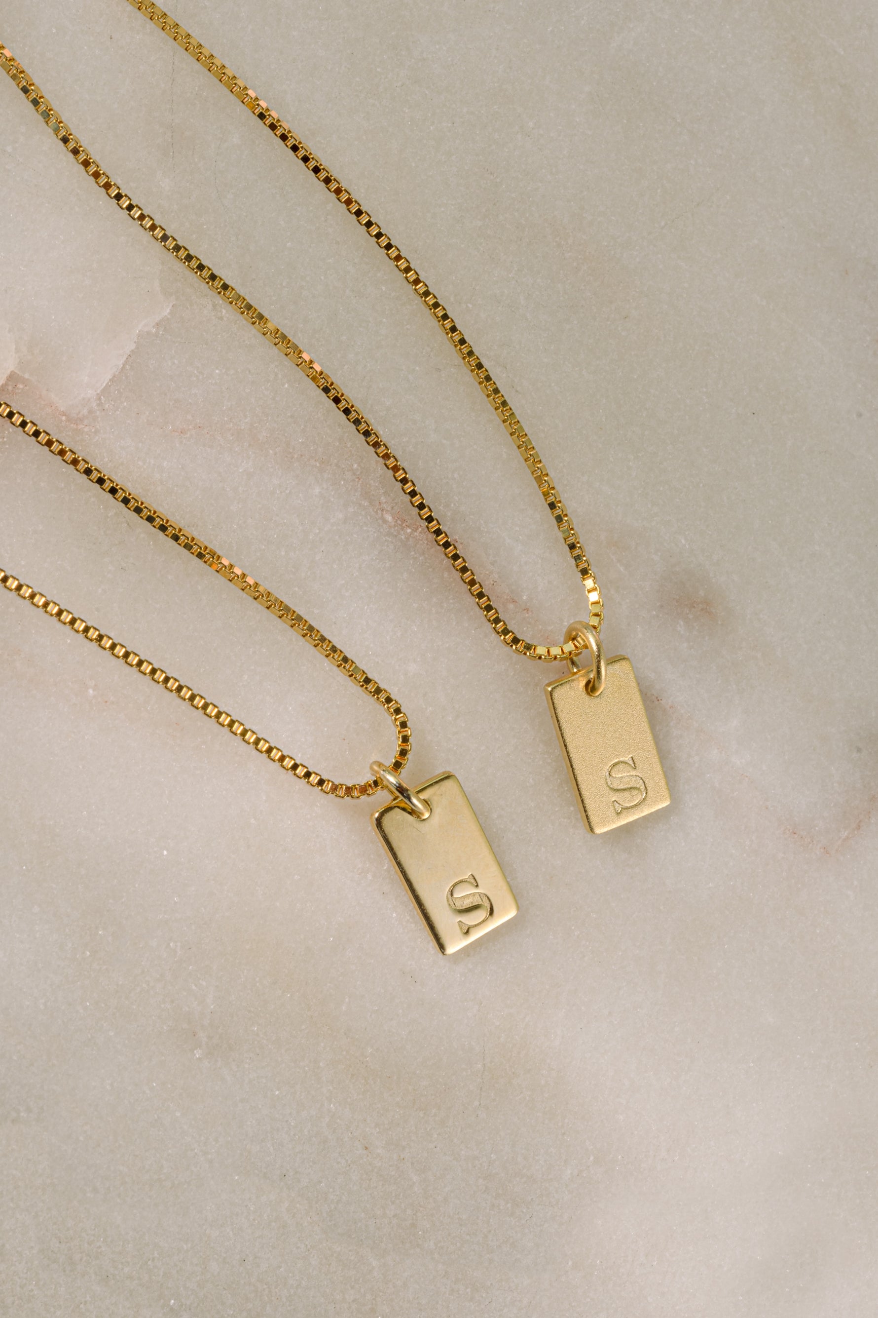 Gold initial tag necklace from Sami Jewels featuring a dainty, personalized initial pendant on a delicate chain.