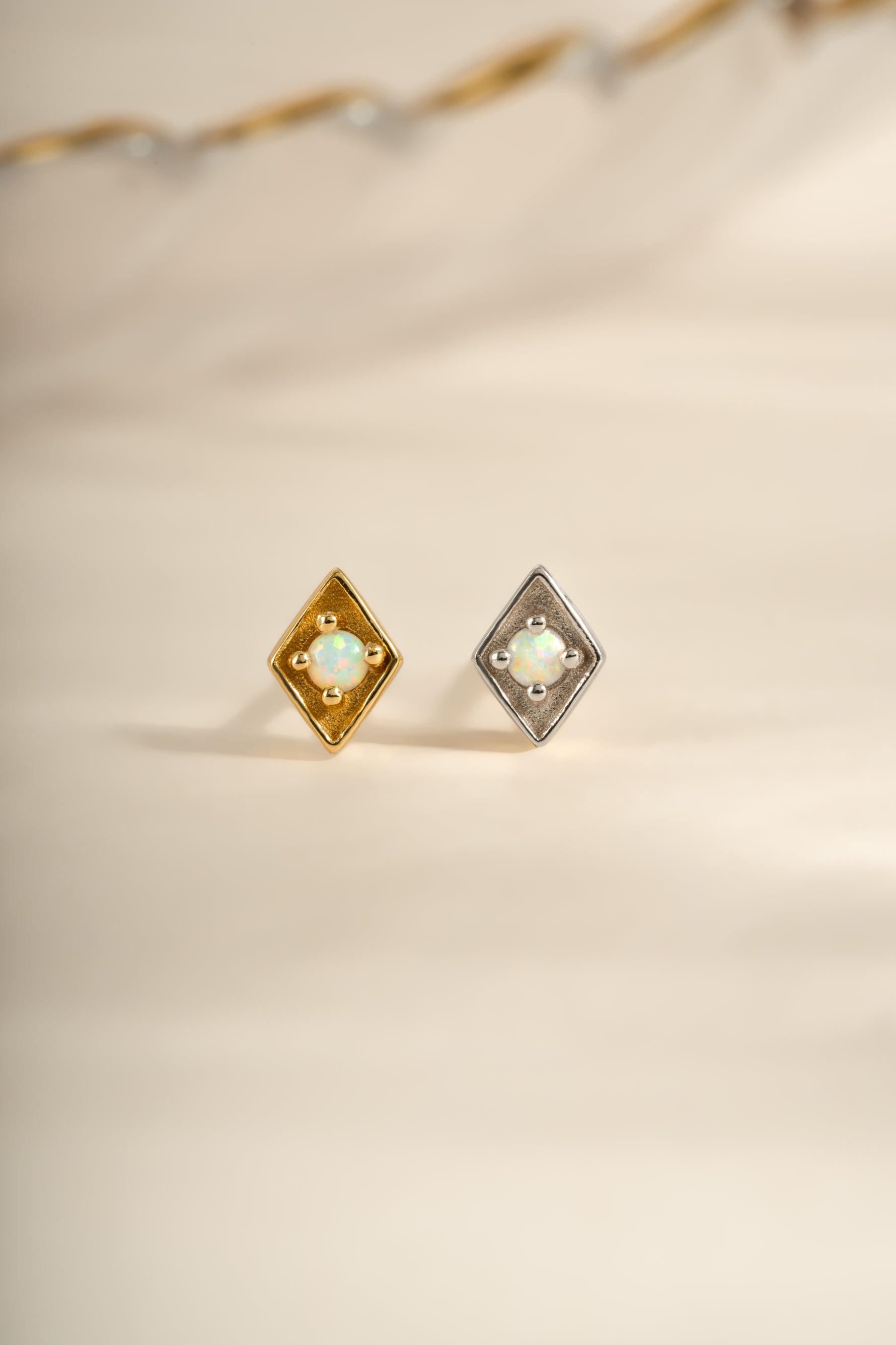 Kite-shaped opal stud earrings by Sami Jewels featuring gold and sterling silver settings.