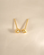 Gold kite-shaped opal stud earrings by Sami Jewels, shown from a top view highlighting their elegant design.