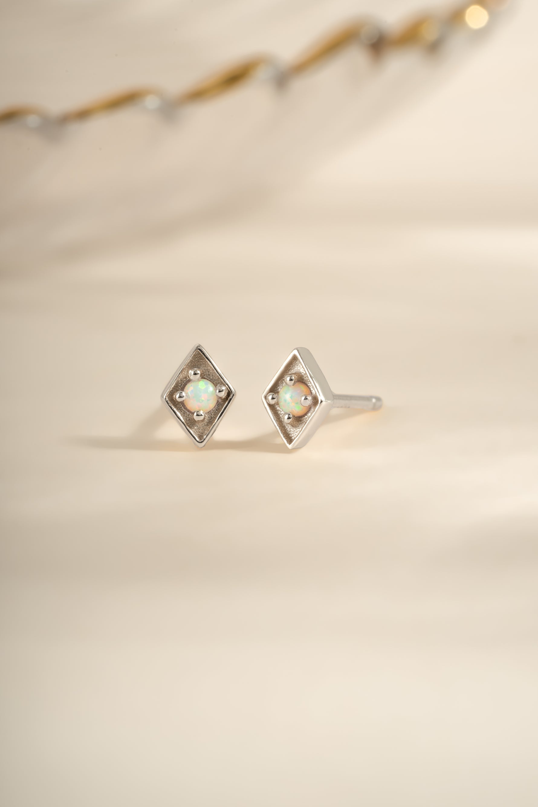 Kite-shaped opal stud earrings by Sami Jewels featuring sterling silver posts and vibrant opal gemstones.