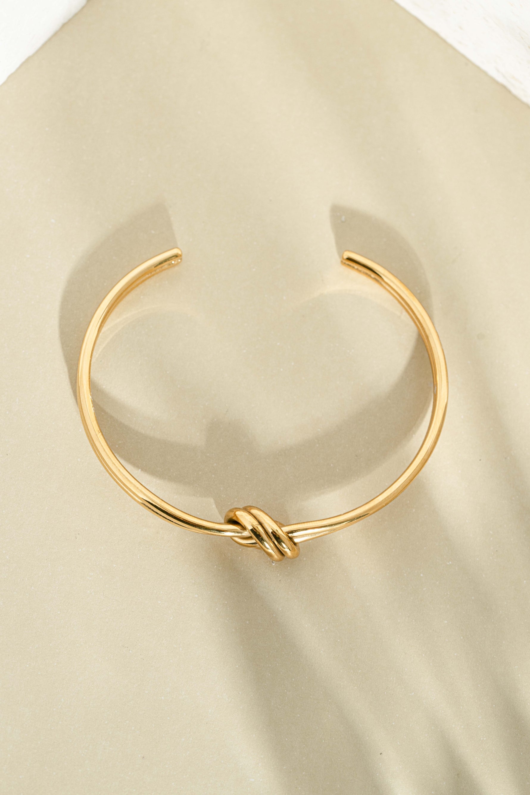 Gold stainless steel SS knotted bangle bracelet by Sami Jewels with a sleek, waterproof design and modern knot detail.