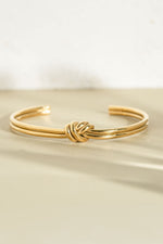 Gold stainless steel SS knotted bangle bracelet by Sami Jewels, featuring a stylish knot design, waterproof and elegant accessory.