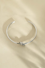 Silver stainless steel SS knotted bangle bracelet with a stylish knotted design, waterproof and durable for everyday wear.