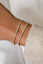 Round bezel and classic tennis bracelets in gold vermeil stacked on the wrist