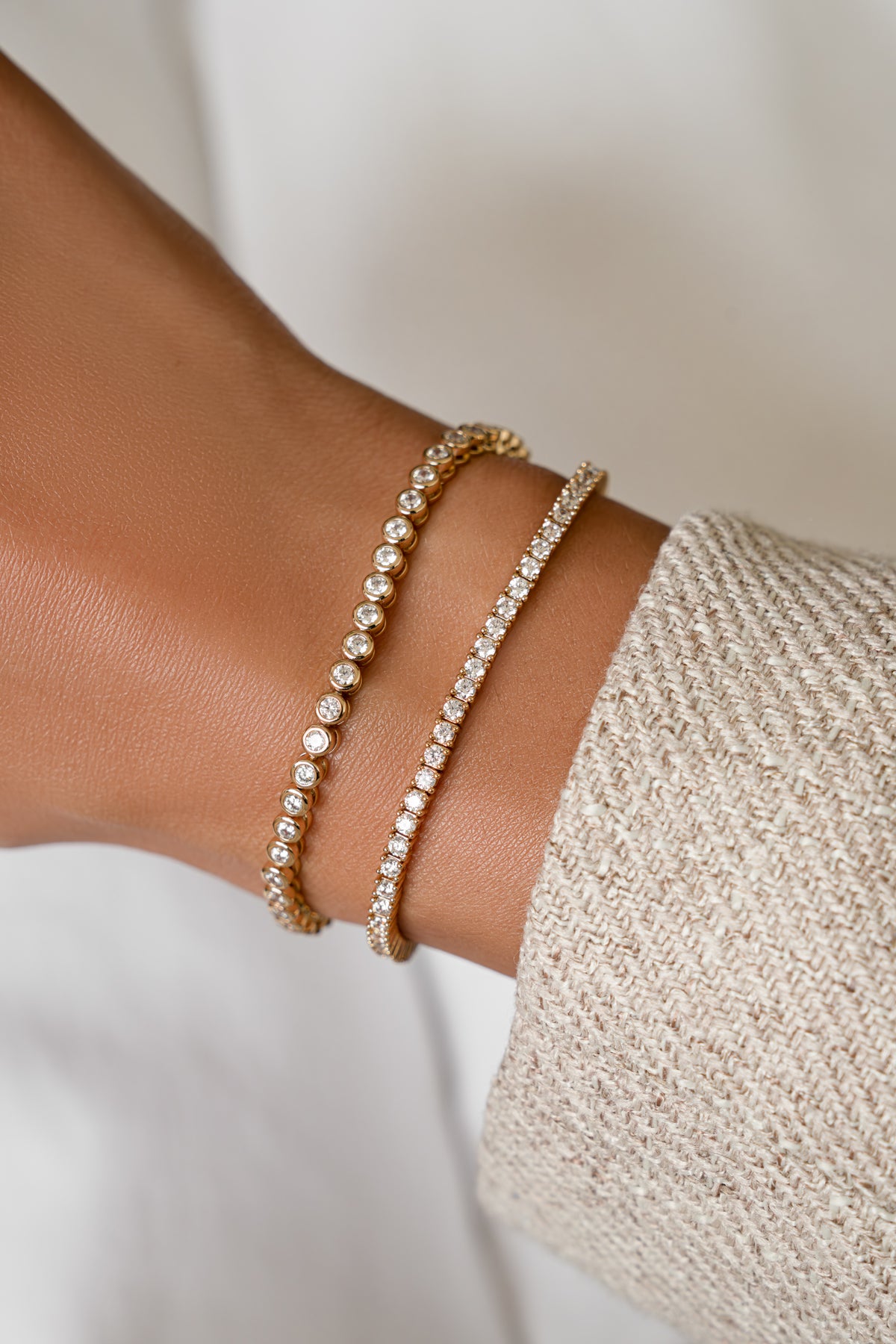 Round bezel and classic tennis bracelets in gold vermeil stacked on the wrist