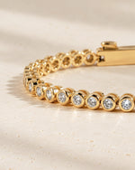 Close-up of the round bezel settings on the lab-grown diamond tennis bracelet