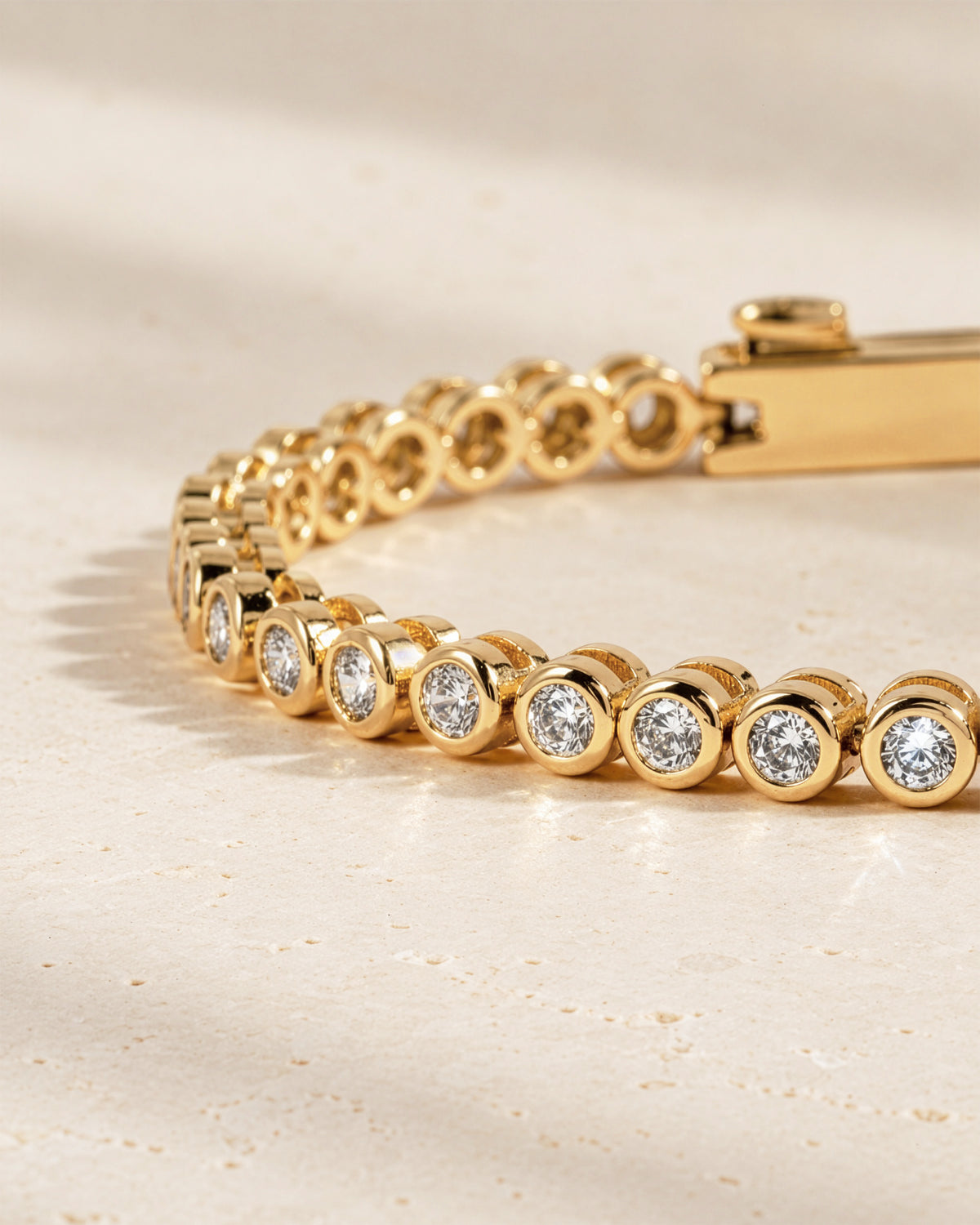 Close-up of the round bezel settings on the lab-grown diamond tennis bracelet