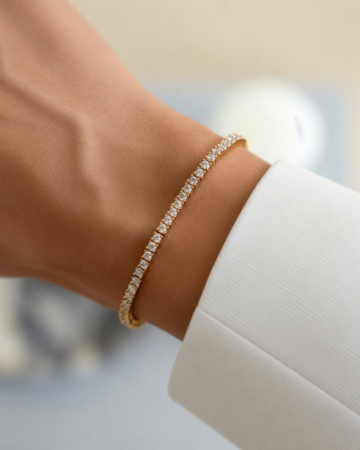 Lab-grown diamond tennis bracelet in gold vermeil worn alone on the wrist