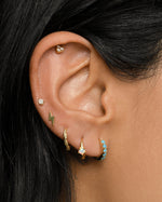 Gold lightning bolt stud earrings by Sami Jewels, featuring sleek, modern lightning bolt design on a model.