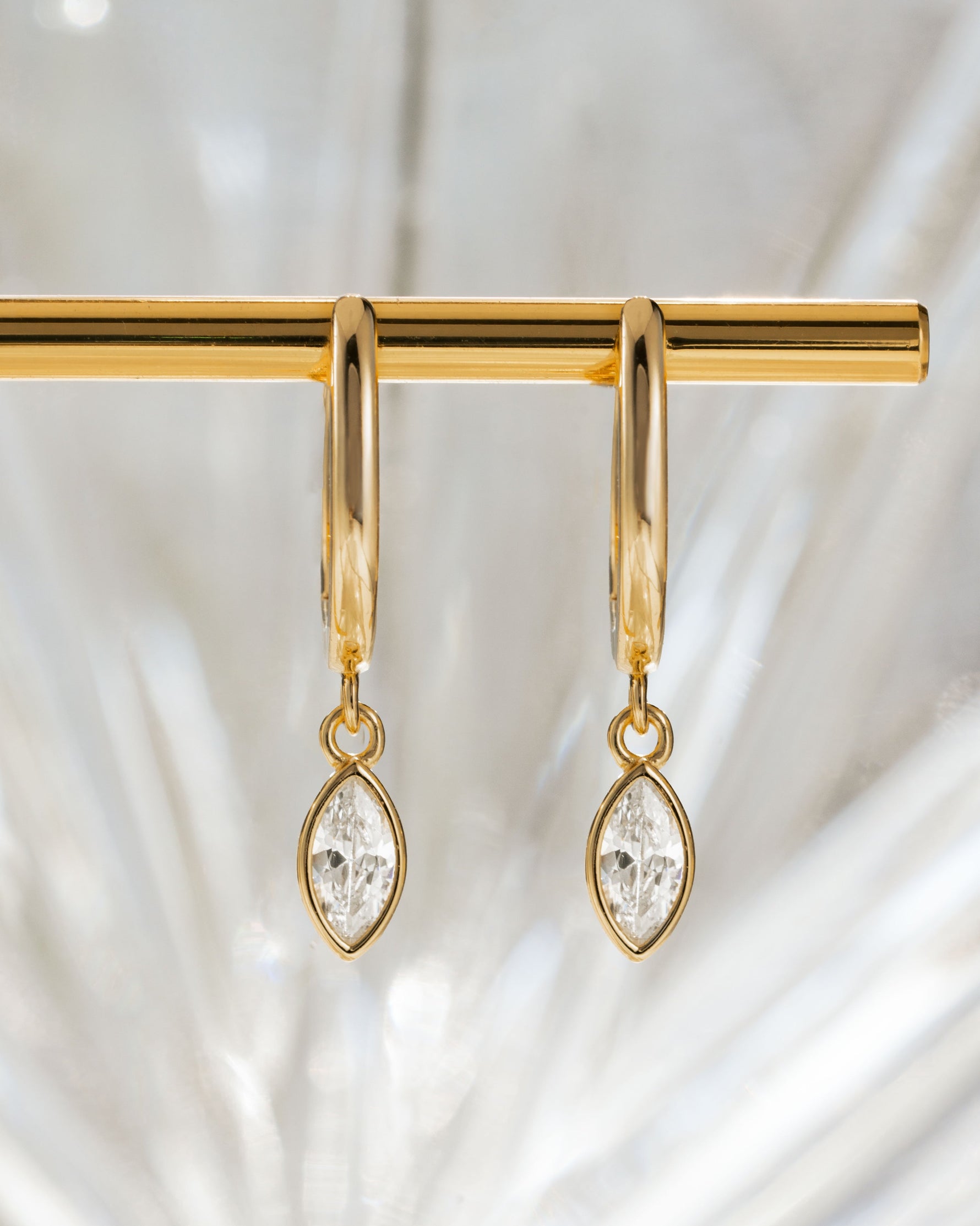 Gold Marquise Bezel Drop Huggie Earrings with stone detail from Sami Jewels, featuring elegant hoop design and sparkling accents.