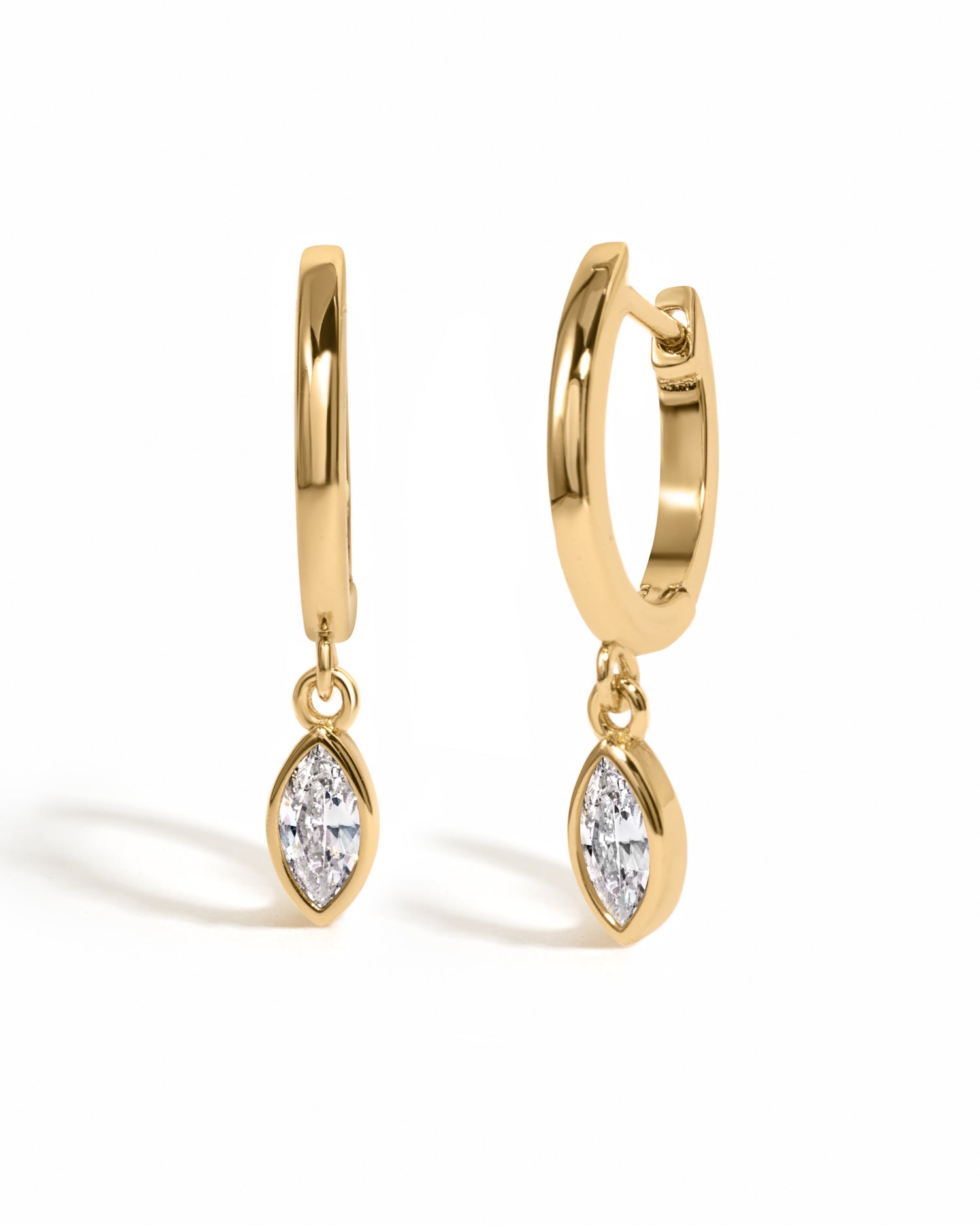 Gold Marquise Bezel Drop Huggie Earrings by Sami Jewels with a sleek hoop design on a white background.