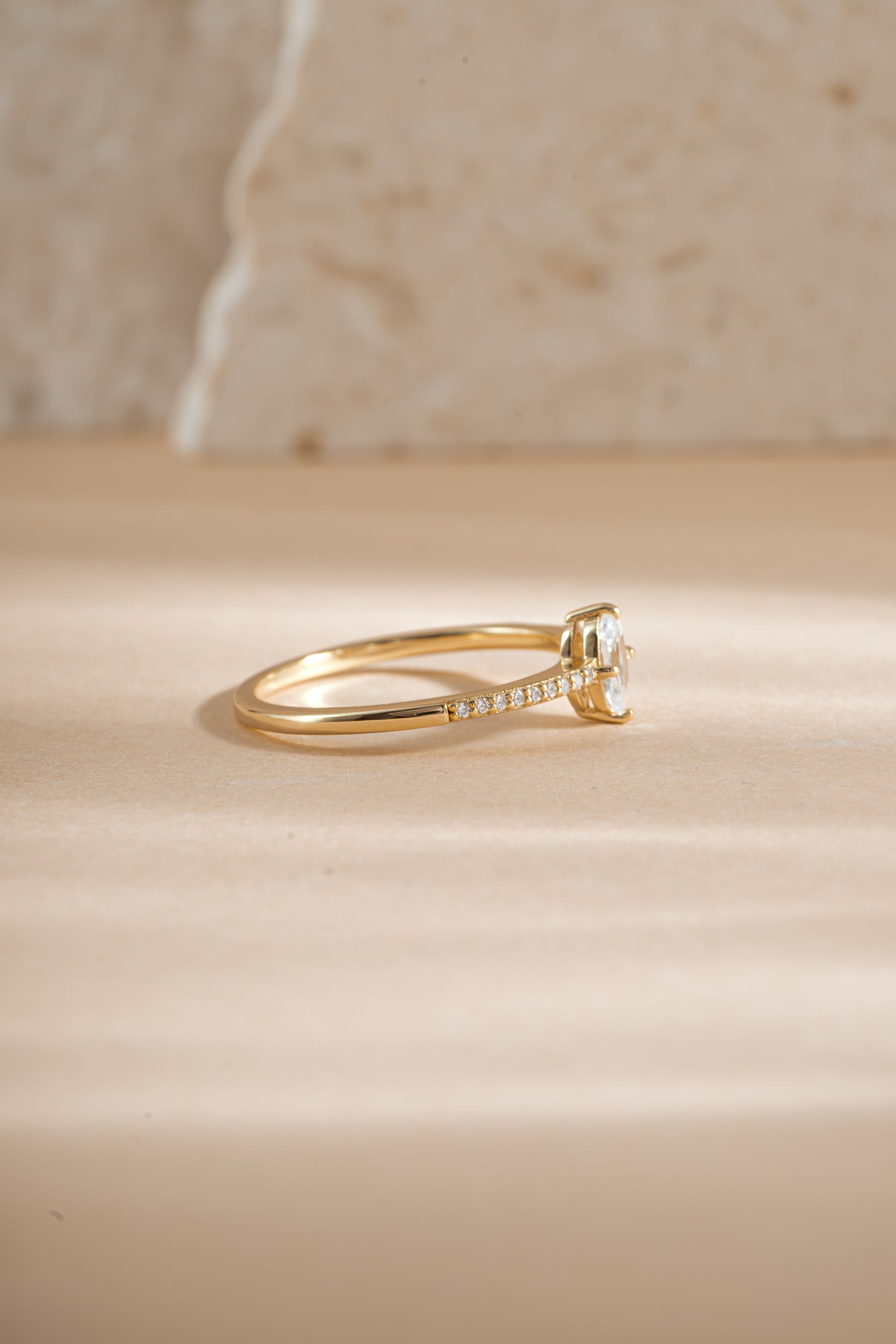 Sami Jewels Maddy Ring with marquise CZ gemstone and pave band in gold, side view showing intricate design details.