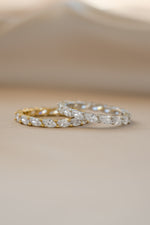 Gold and sterling silver Sami Jewels marquise eternity ring with continuous gemstone design.