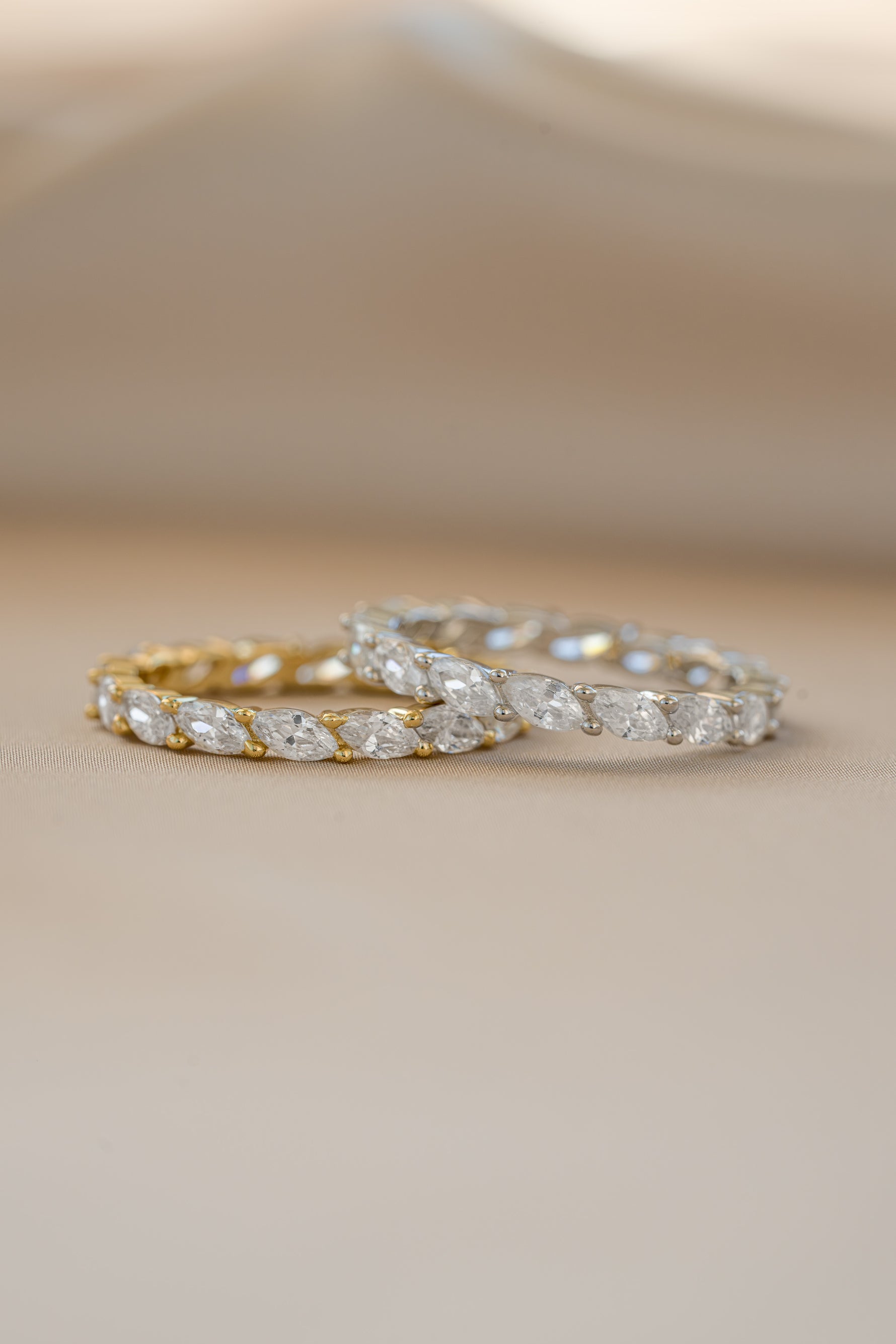Gold and sterling silver Sami Jewels marquise eternity ring with continuous gemstone design.