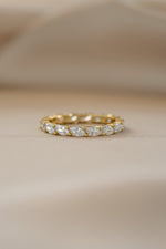 Gold Marquise Eternity Ring from Sami Jewels featuring a continuous row of marquise-shaped gemstones in a sleek band.