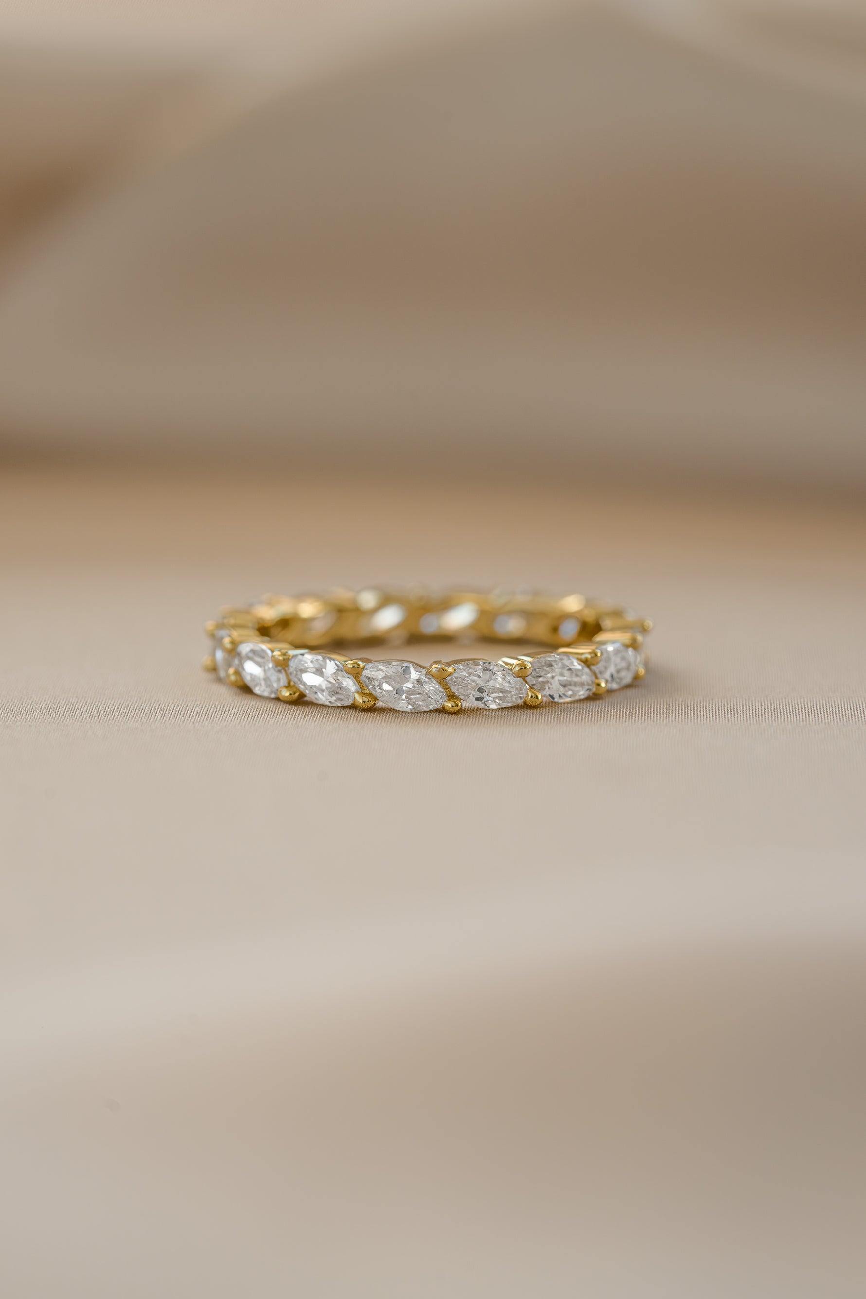 Gold Marquise Eternity Ring from Sami Jewels featuring a continuous row of marquise-shaped gemstones in a sleek band.