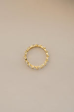 Gold Marquise Eternity Ring by Sami Jewels, showcasing a sleek band with marquise-shaped gemstones in a continuous design.
