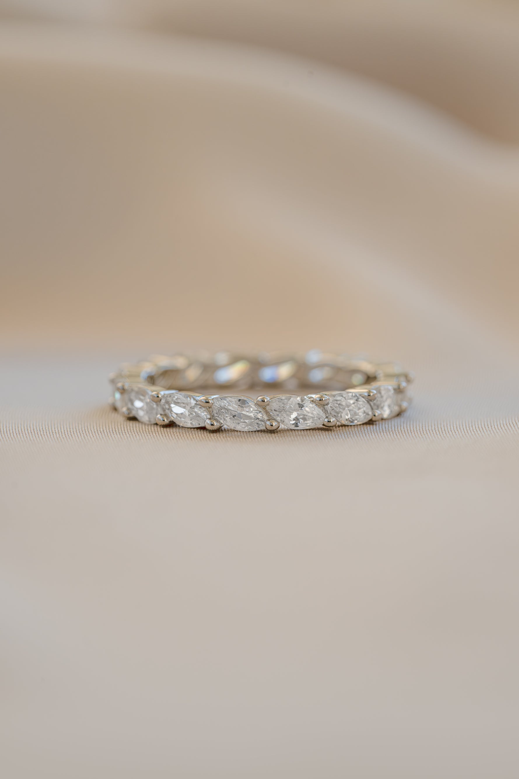 Close-up of Sami Jewels marquise eternity ring featuring sterling silver band with marquise-shaped gemstones.