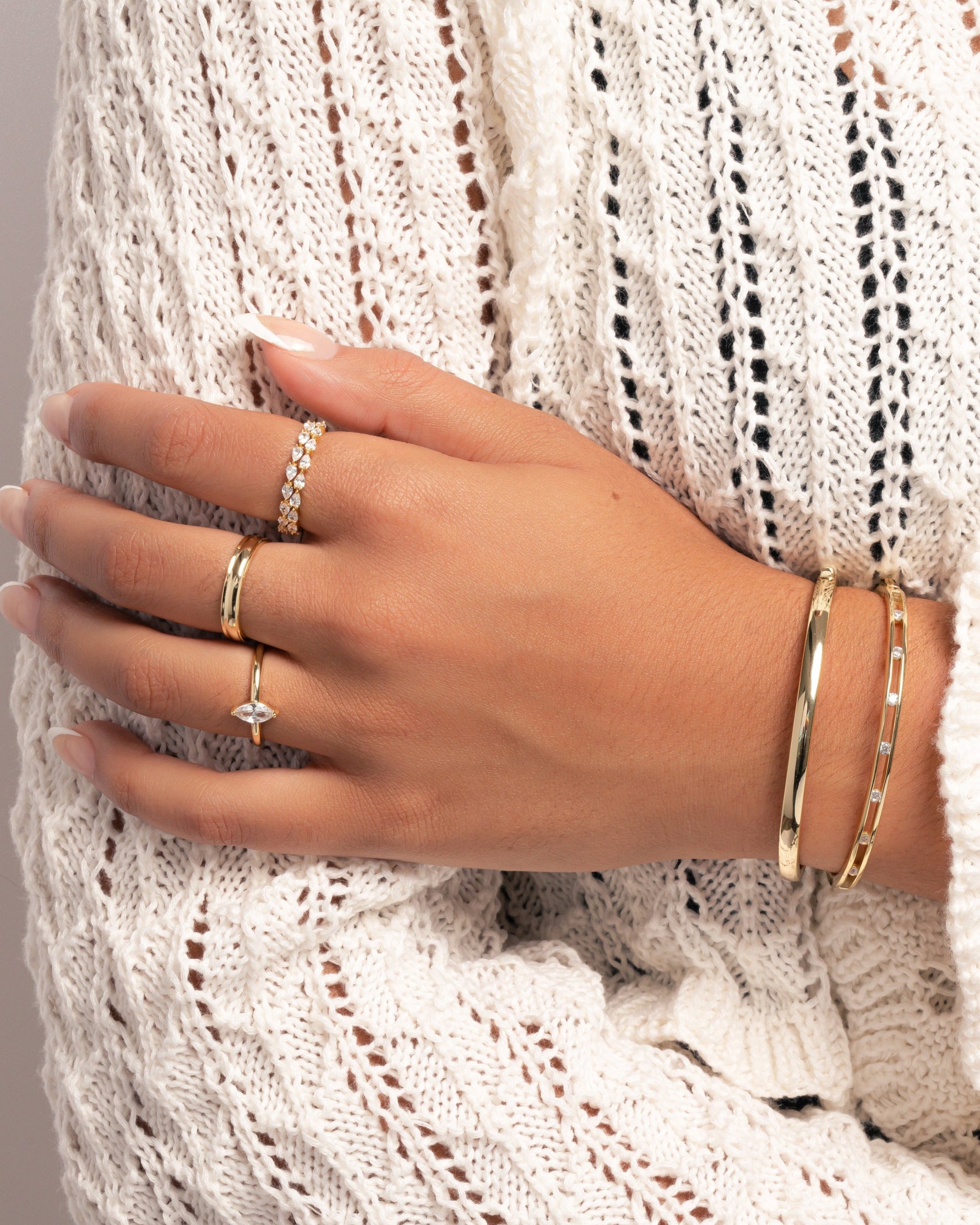 Gold Solitaire Marquise Ring by Sami Jewels, featuring a marquise-cut gemstone styled on a model's hand.