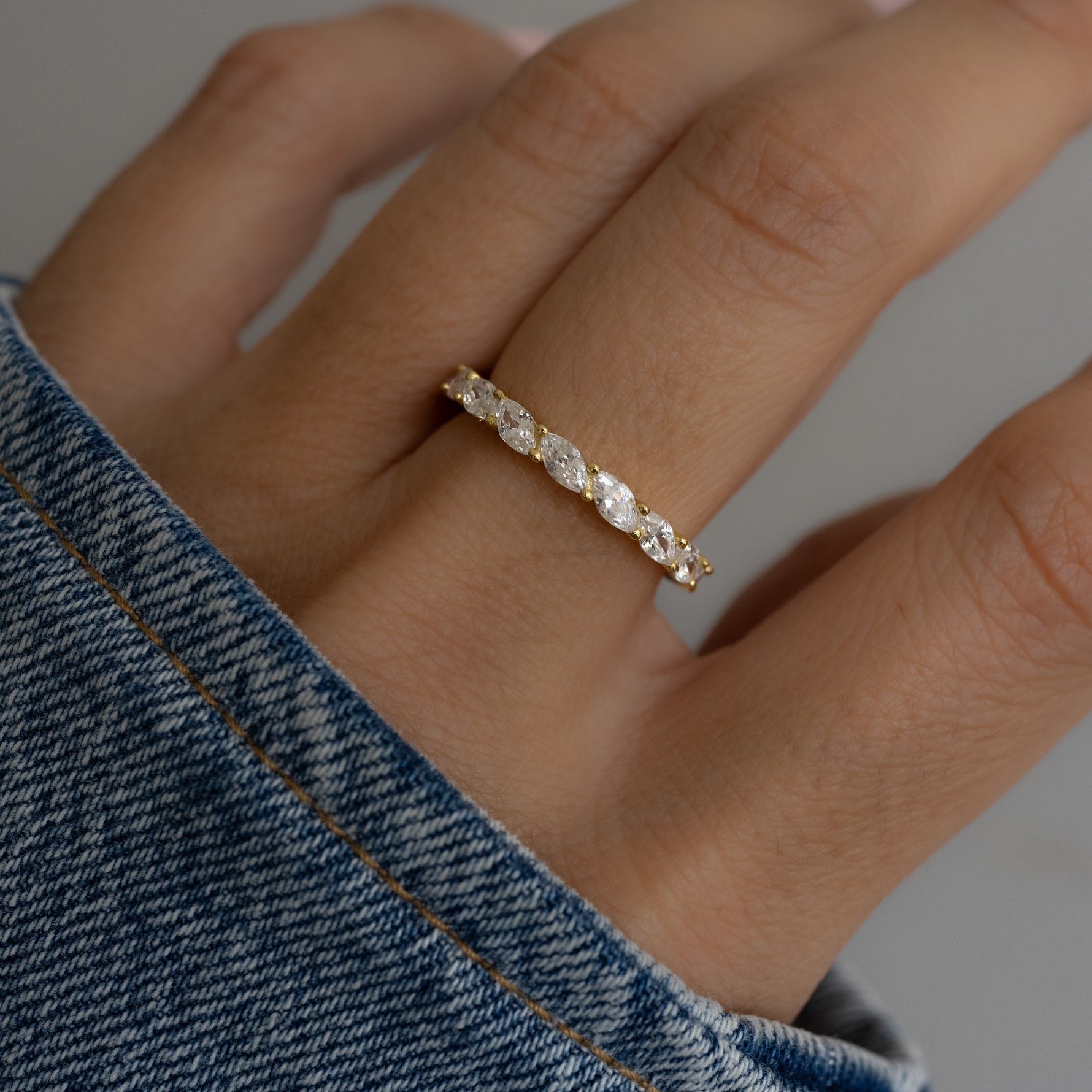 Worn solo by the model,  this eternity ring makes a refined statement, effortlessly blending with casual looks. 