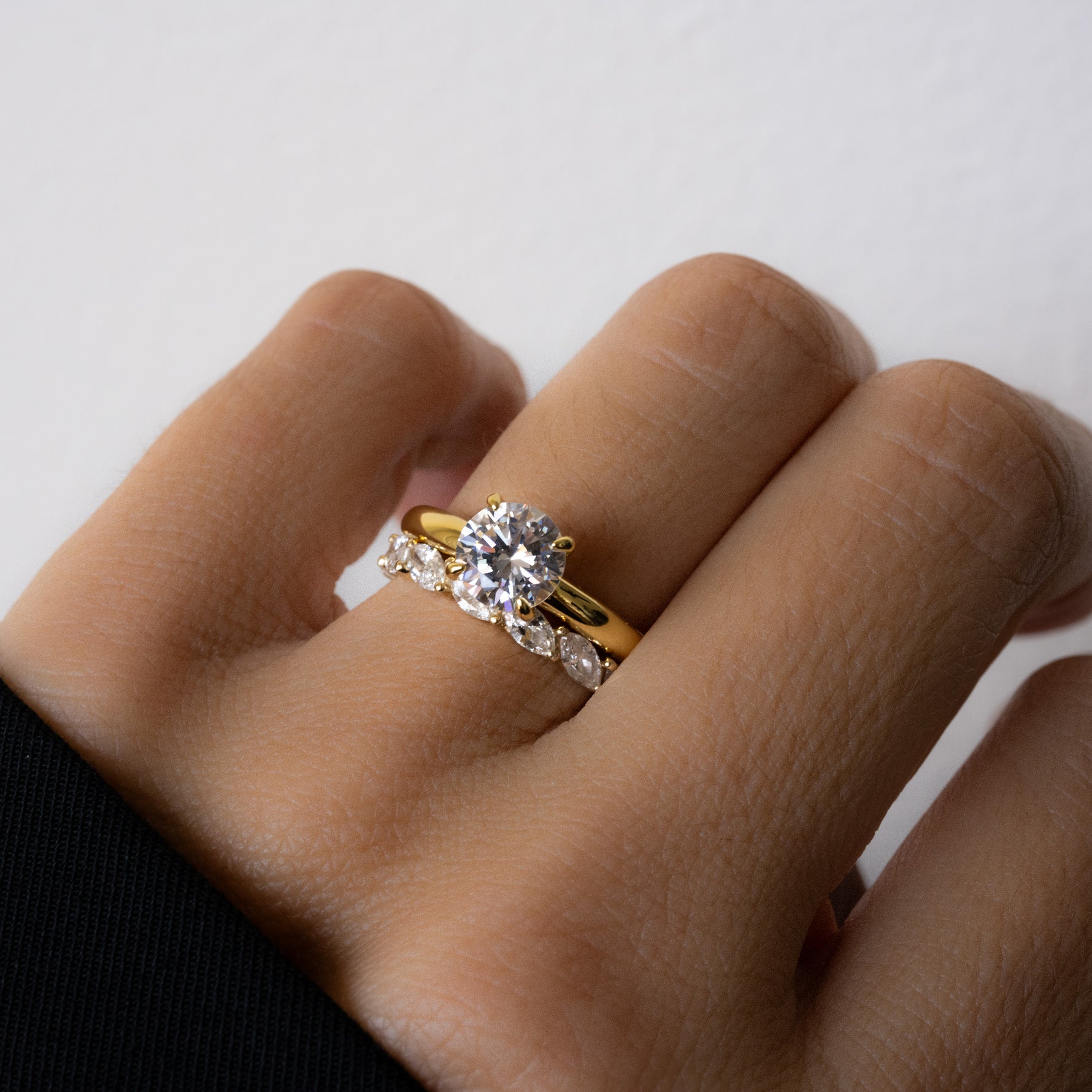 Paired with an engagement ring, model is wearing eternity ring on the ring finger, adds elegant sparkle as wedding jewelry. 
