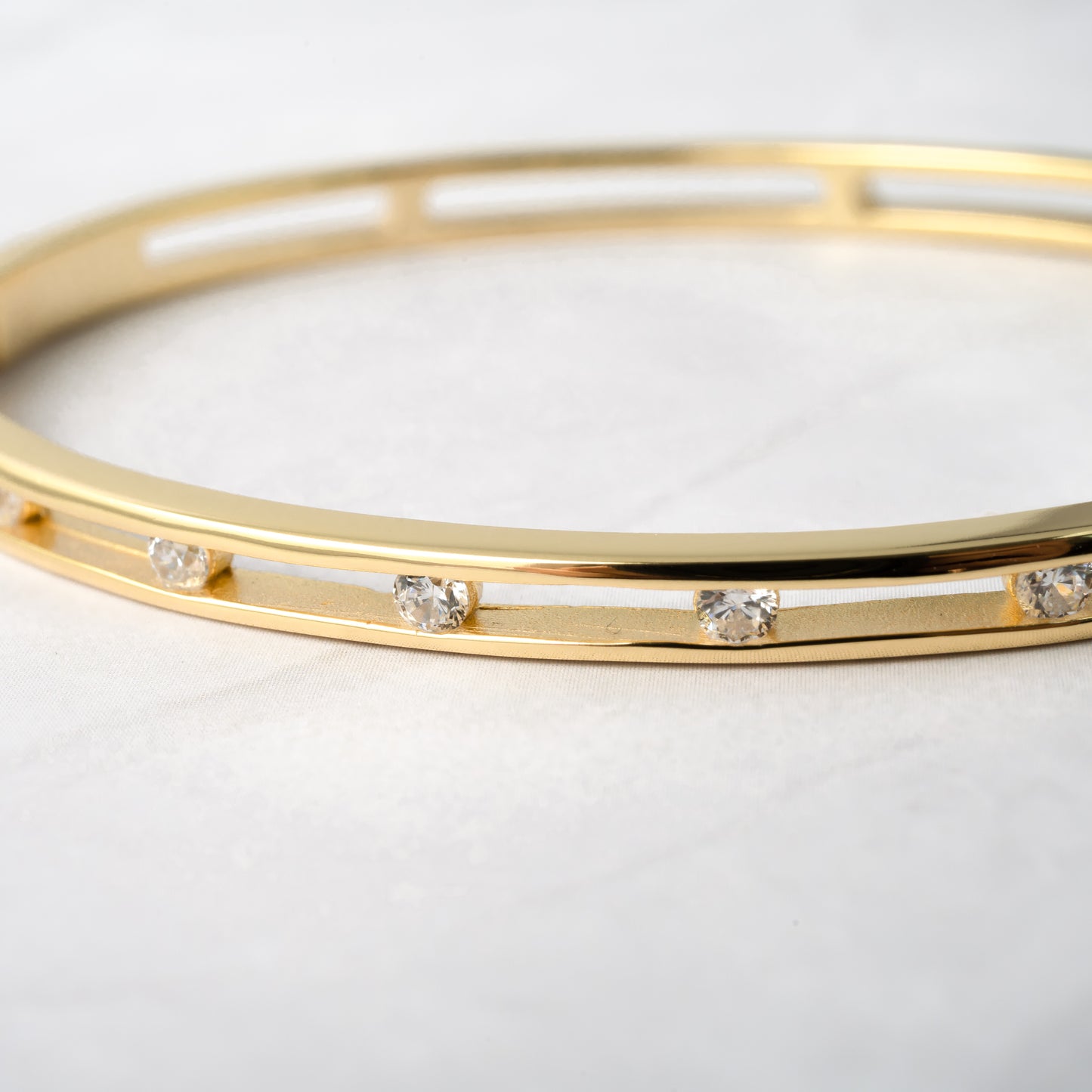 close up of a gold bangle bracelet